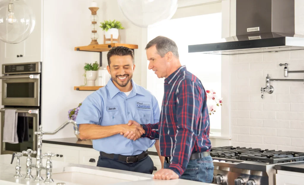 Chapman Heating, Air Conditioning & Plumbing HVAC technician discussing the best way to finance a new HVAC system in Indianapolis with a customer.